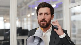 Businessman in suit speaking into megaphone making announcement at the office, sharing good news to colleagues. - Powered by Shutterstock - Get 15% off with code: PIKWIZARD15
