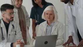 Discussion and team of diverse doctors in hospital for collaboration on medical diagnosis. Conversation, career and group of professional healthcare workers with digital technology in medicare clinic - Powered by Shutterstock - Get 15% off with code: PIKWIZARD15