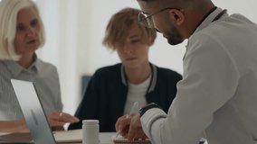 Consultation with a family doctor in a clinic. general medicine doctor in a medical uniform, advises the patient, prescribes treatment, listens to complaints, gives advice, shows medicines - Powered by Shutterstock - Get 15% off with code: PIKWIZARD15