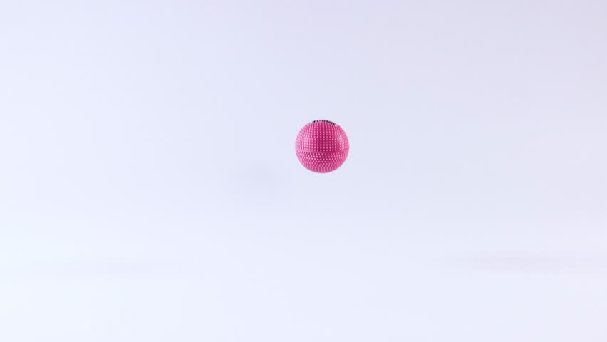 A pink ball bounces in a white space