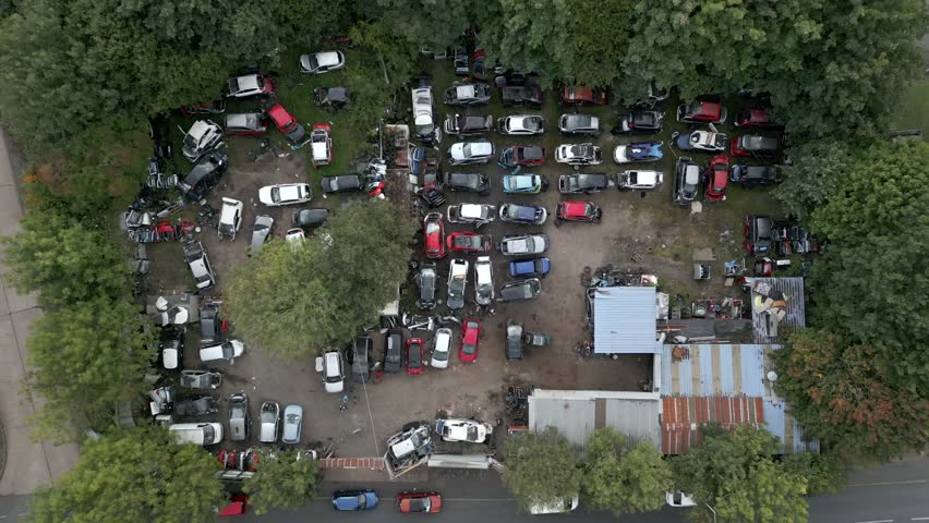 Drone aerial view of a car salvage yard full of old scrap vehicles