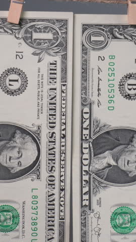 A close-up of a one-dollar bill shows George Washington