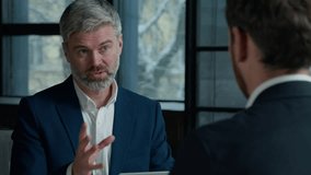 Caucasian man businessman ceo hr director having interview meeting hiring recruit at job male applicant in office consultant manager advising client men businessmen communicate at business negotiation - Powered by Shutterstock - Get 15% off with code: PIKWIZARD15