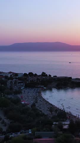 Vertical video of the beach - high quality vertical video taken from the air with a drone of people swimming and sunbathing in summer