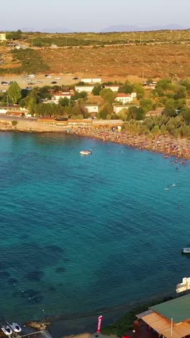 Vertical video of the beach - high quality vertical video taken from the air with a drone of people swimming and sunbathing in summer