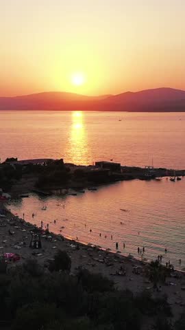 Vertical video of the beach - high quality vertical video taken from the air with a drone of people swimming and sunbathing in summer