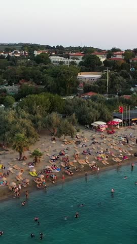 Vertical video of the beach - high quality vertical video taken from the air with a drone of people swimming and sunbathing in summer