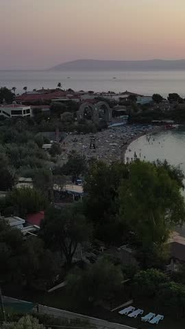 Vertical video of the beach - high quality vertical video taken from the air with a drone of people swimming and sunbathing in summer