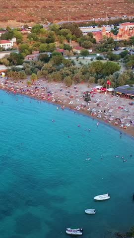 Vertical video of the beach - high quality vertical video taken from the air with a drone of people swimming and sunbathing in summer