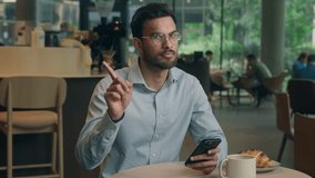 Indian Arabian man freelancer businessman guy business tourist visitor in cafe restaurant male user mobile phone dissatisfied looking at camera shaking finger no answer forbid reject not deny gesture - Powered by Shutterstock - Get 15% off with code: PIKWIZARD15