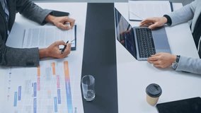 Top View of a Business Meeting With Interactive Holographic Data Visualization. Professionals Analyze Charts, Graphs, and Percentages Projected. AI Technology in Modern Corporate Revenue Growth - Powered by Shutterstock - Get 15% off with code: PIKWIZARD15
