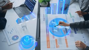 Top View of a Business Meeting With Interactive Holographic Data Visualization. Professionals Analyze Charts, Graphs, and Percentages Projected. AI Technology in Modern Corporate Revenue Growth - Powered by Shutterstock - Get 15% off with code: PIKWIZARD15