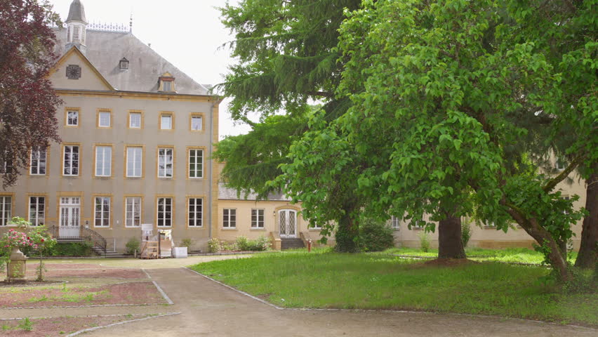Profile view of vacant Schengen Castle in Luxembourg during daytime. Peaceful afternoon.