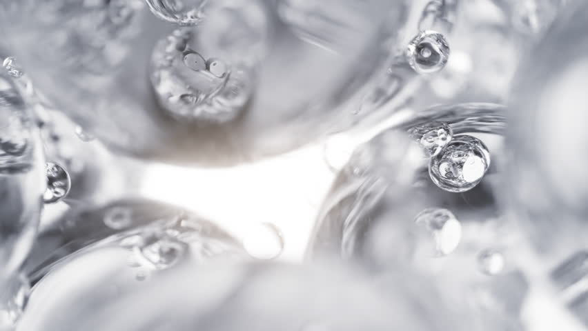 Clear cosmetic serum with liquid bubbles in a 3D abstract background. Hydrating essence gel enriched with collagen molecules. Moisturizing cream or oil for advanced skincare, beauty, and skin health. 