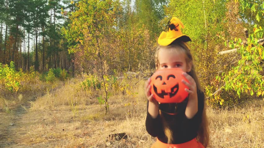Portrait of smiling girl trick or treating in halloween costume. Childhood, tradition and halloween concept.
