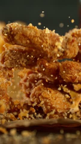 Super Slow Motion of Flying Fried Chicken Pieces. Filmed on High Speed Cinema Camera, 1000fps. Vertical Aspect Ratio.