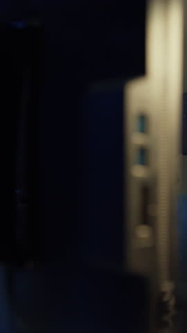 Vertical Screen : Happy asia guy blogger music influencer record a podcast on computer with headphones and microphone talk with audience in living room home studio at night. Content creator concept.