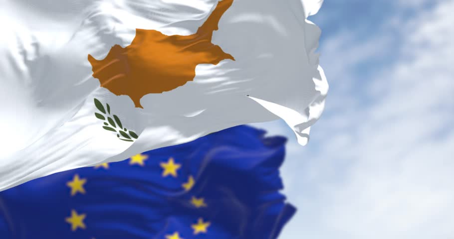 Cyprus national flags waving in the wind with the European Union flags on a clear day. Seamless 3d render animation. Slow motion loop. Selective focus