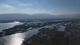 4k aerial view of sunlight reflection over lake of flood plain and marshy area (longoz ormanı) - Powered by Shutterstock - Get 15% off with code: PIKWIZARD15