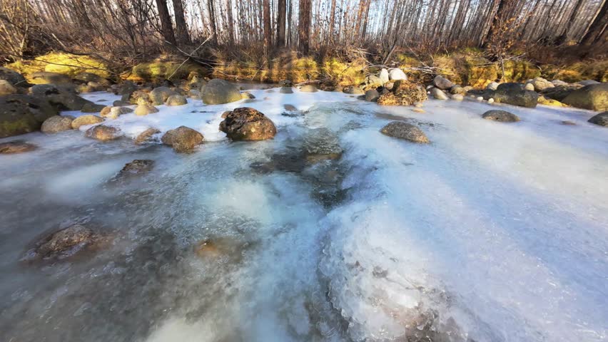 Experience the breathtaking beauty of Yakutia as a drone glides over icy rivers and snow-covered rocks, showcasing nature