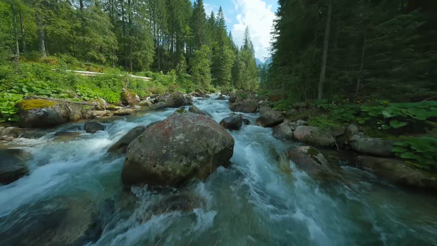 Flight over a mountain river. Shot on FPV drone. Tatra Mountains, Slovakia.