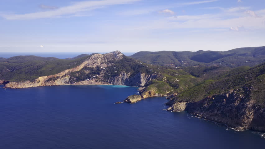Ibiza Coast Landscape with Bays, Deep Turquoise Water, and Clear Blue Skies – Flyover