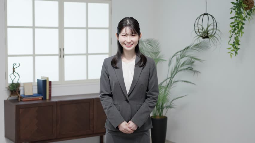 Asian business woman standing with a smile