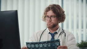 A Doctor Works in a Modern Office, Analyzing Digital Medical Data and X-rays on His Computer to Provide Accurate Diagnoses. Digital Data in Healthcare, Precision and Modern Diagnostic Techniques. - Powered by Shutterstock - Get 15% off with code: PIKWIZARD15