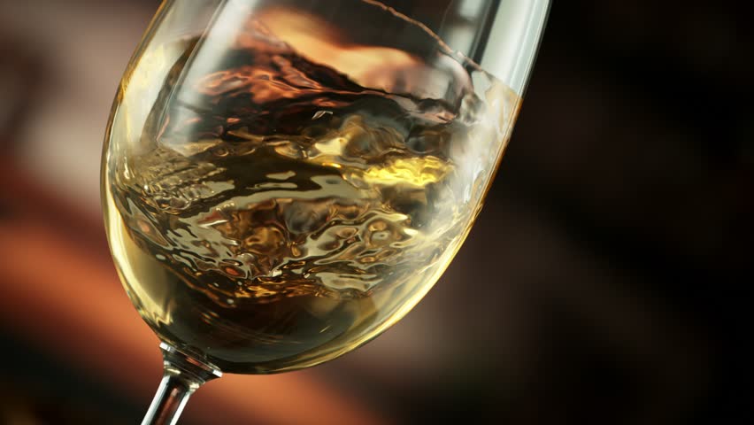Super Slow Motion Detail Shot of Spinning White Wine in Glass at 1000fps.