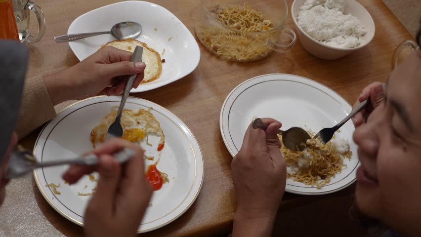 Asian couple, husband and wife eating dinner at home