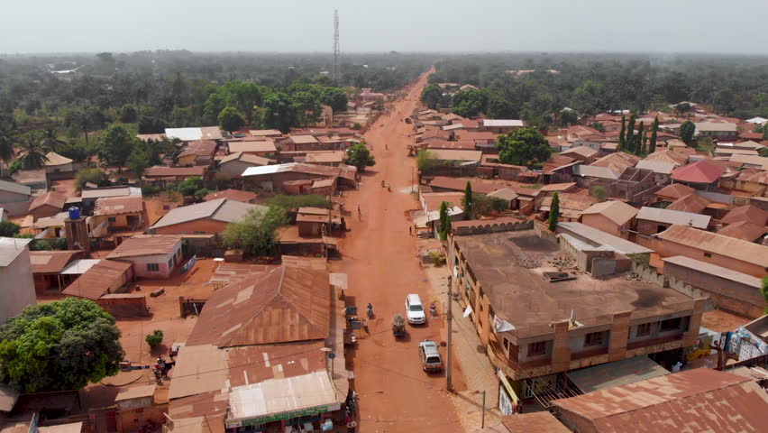 Ouidah Benin West Africa city, roads houses covered in red dust, aerial drone