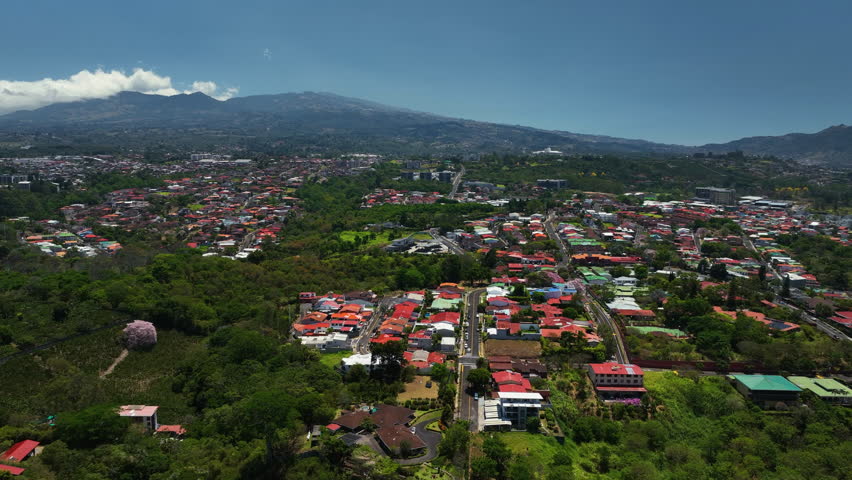 Drone flying over a streets and a community of homes, in San Jose, Costa Rica