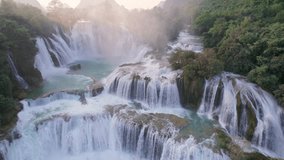 Aerial view of majestic Ban Gioc Waterfall, Detian Falls flowing amidst tropical forest during the sunset at Cao Bang, Vietnam - Powered by Shutterstock - Get 15% off with code: PIKWIZARD15