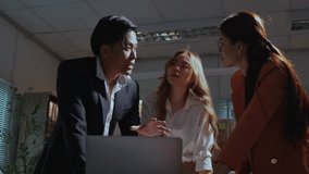 Business team engages in a heated discussion while reviewing work on a laptop in a modern office setting - Powered by Shutterstock - Get 15% off with code: PIKWIZARD15