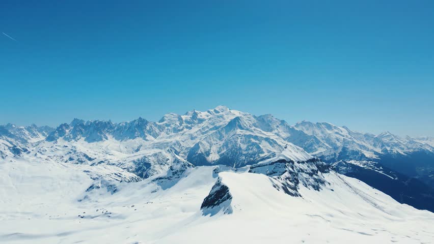 Aerial drone view of Grand Massif area within sight of Mont Blanc, France. Snowy winter in French Alps, ski resort Flaine. Static footage. Clear sky. Winter landscape.