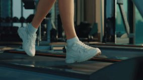 Close Up of Female Person's Feet Running on a Treadmill in a Gym. Jogging. Healthy Lifestyle. Woman in professional sneakers runs on treadmill at gym closeup - Powered by Shutterstock - Get 15% off with code: PIKWIZARD15