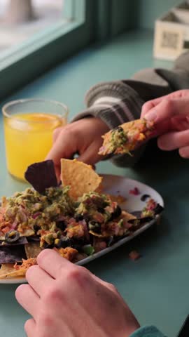 couple enjoying a meal together in a restaurant. Mexican .nachos, Mexican food