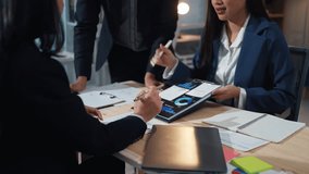 Business team discussing financial data on a tablet during a meeting, analyzing charts and graphs for strategic insights - Powered by Shutterstock - Get 15% off with code: PIKWIZARD15