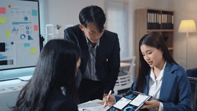 Group of three asian businesspeople are having a meeting in an office, discussing about data on a tablet - Powered by Shutterstock - Get 15% off with code: PIKWIZARD15