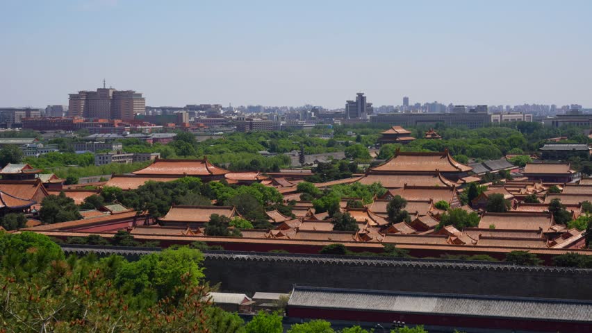 Ancient Forbidden City roof tops and modern Beijing in background, China
