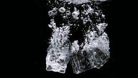 ice cubes in a glass of water in slow motion and on black background - Powered by Shutterstock - Get 15% off with code: PIKWIZARD15
