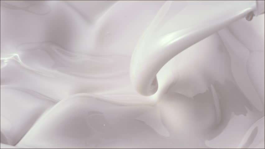 creamy milk pouring and splashing in slow motion