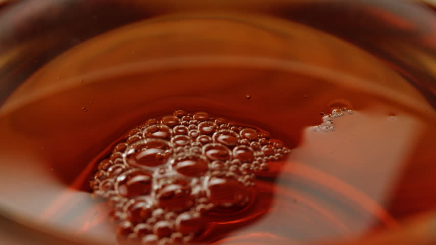 Pouring milk into black english breakfast tea in glass cup. Drinking hot tea with milk, healthy morning, freshly brewed detox drink.