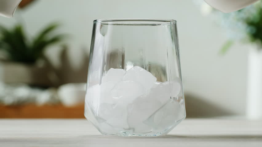 Ice coffee latte with cream being poured into it showing the texture and refreshing look of the drink, with a clean background.