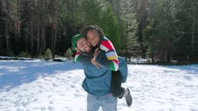 African american couple delights in a playful moment amidst the soft, glistening snow at Yosemite National Park, beautifully deep affection against a serene and breathtaking winter landscape - Powered by Shutterstock - Get 15% off with code: PIKWIZARD15