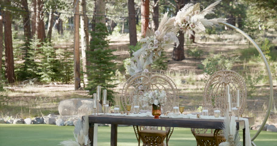 Breathtaking outdoor wedding reception sweetheart table that showcases beautiful wedding celebration of love at outdoor summer daylight settings 