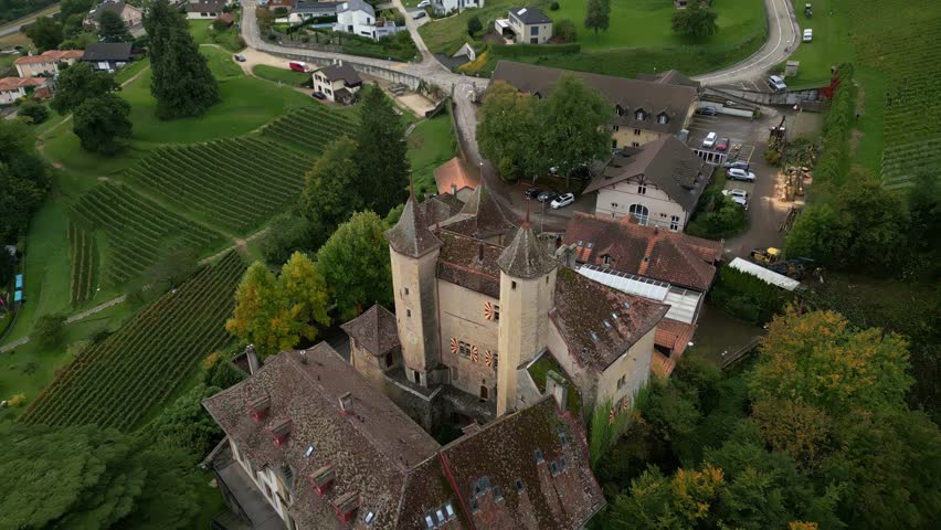 Pull back tilt up drone shot of Vaumarcus Castle in Canton of Neuchatel Switzerland