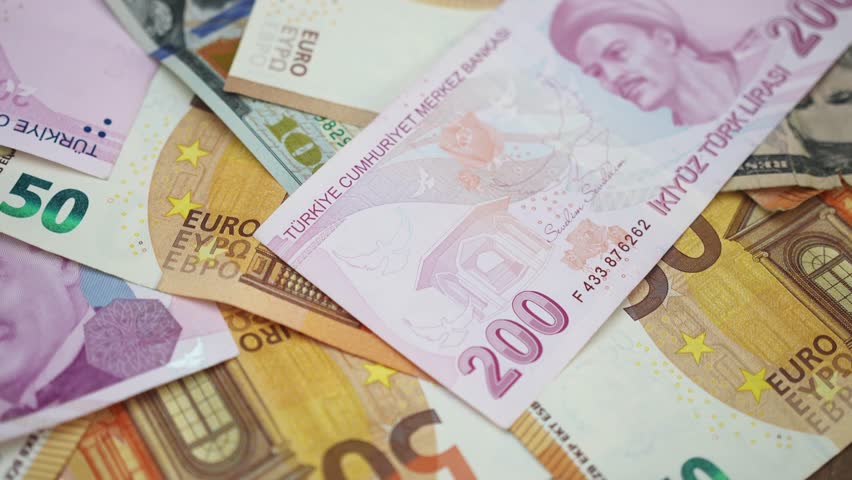 Turkish lira American dollar and euro banknotes on table illustrating escalating inflation significantly diminishing lira value compared to more stable currency - Powered by Shutterstock - Get 15% off with code: PIKWIZARD15