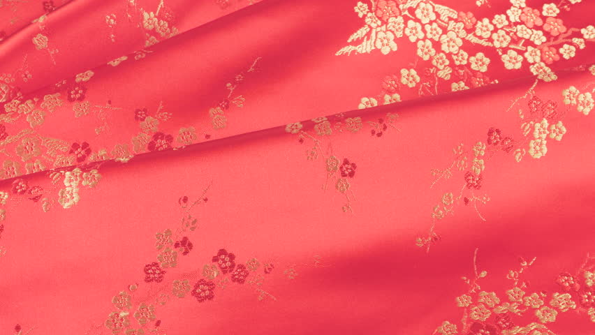Lustrous pink silk rose shade fabric background with white floral embroidery in oriental style with plum blossom flower pattern. Soft folds of brocade shimmers beautifully on a rotating display case. 