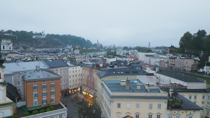 Aerial perspective of Salzburg, Austria showcasing the Salzach River meandering through the city center and downtown buildings